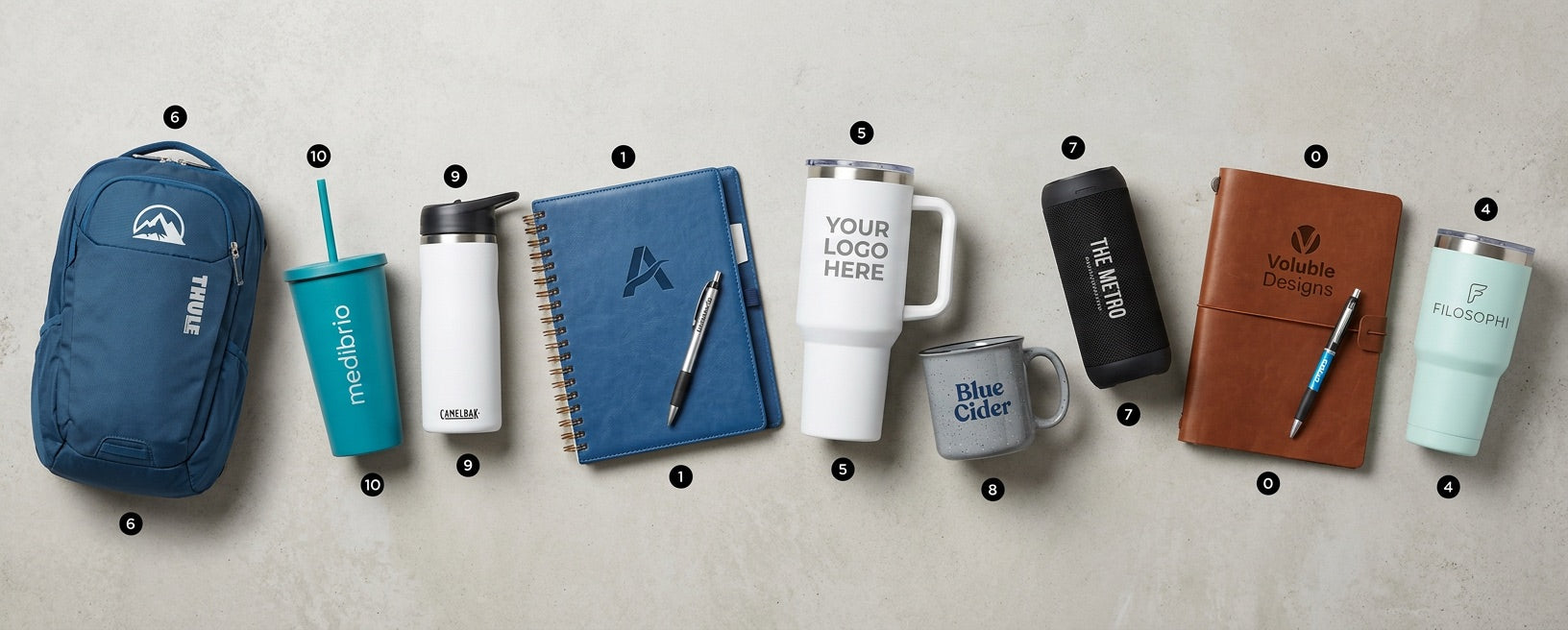 Range of customizable branded merchandise — bags, drinkware, journals and tech — ready for your company logo